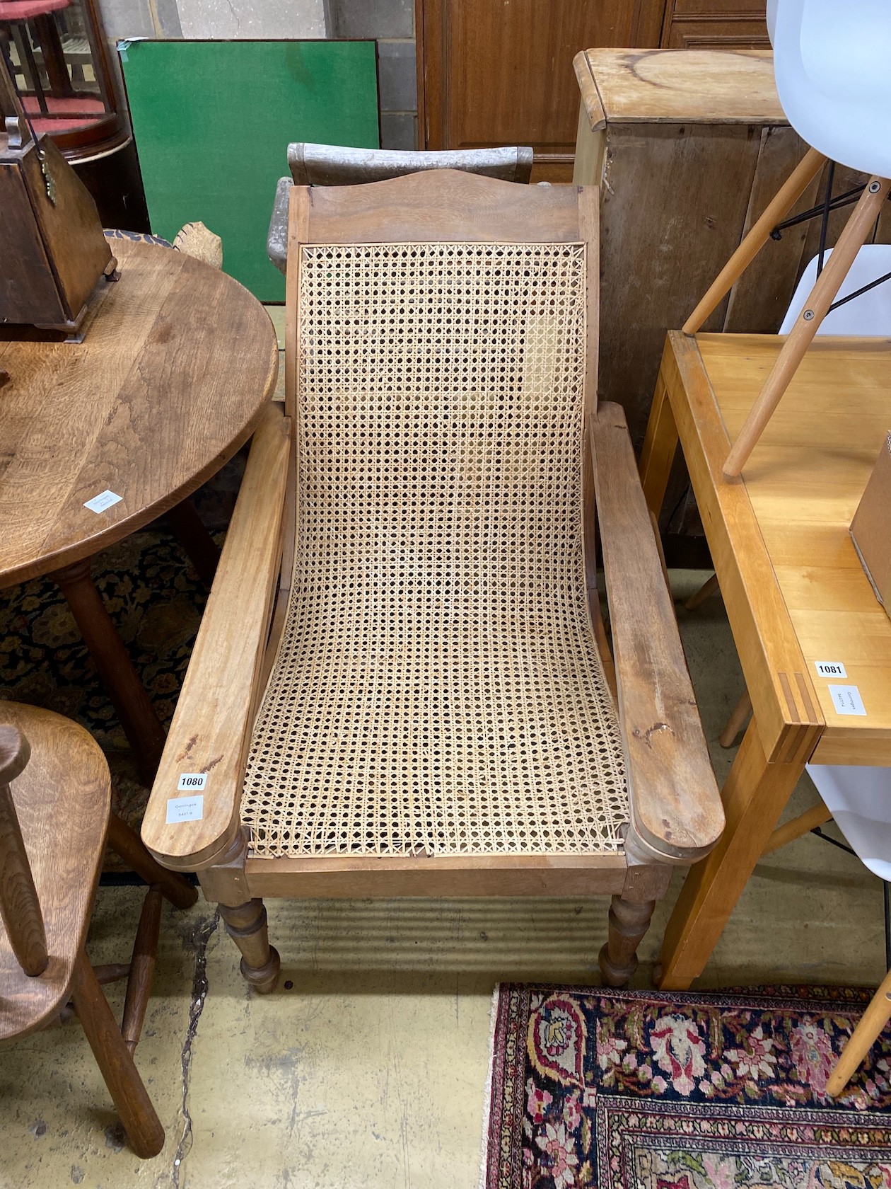 A caned hardwood plantation chair, width 66cm, depth 100cm, height 90cm